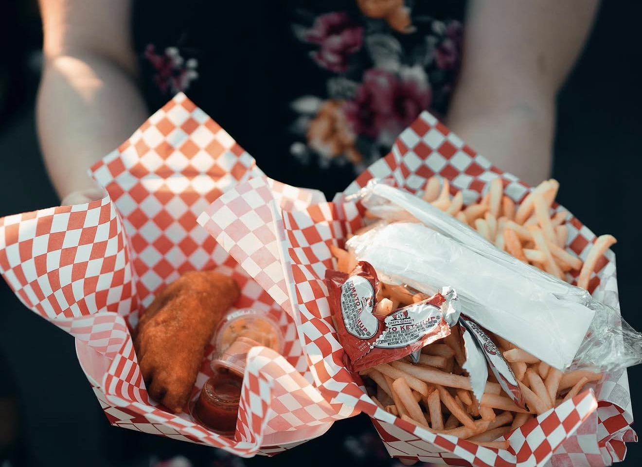 Empanadas and fries combo served in checkered paper
