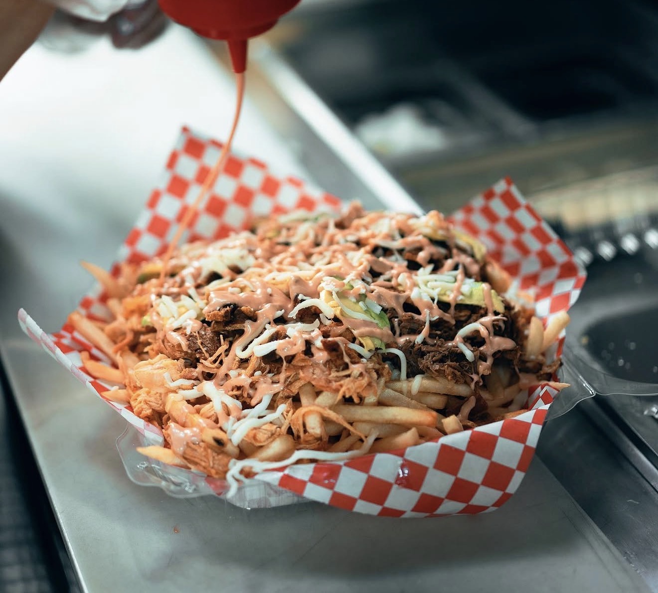 Loaded fries topped with seasoned meat and sauces