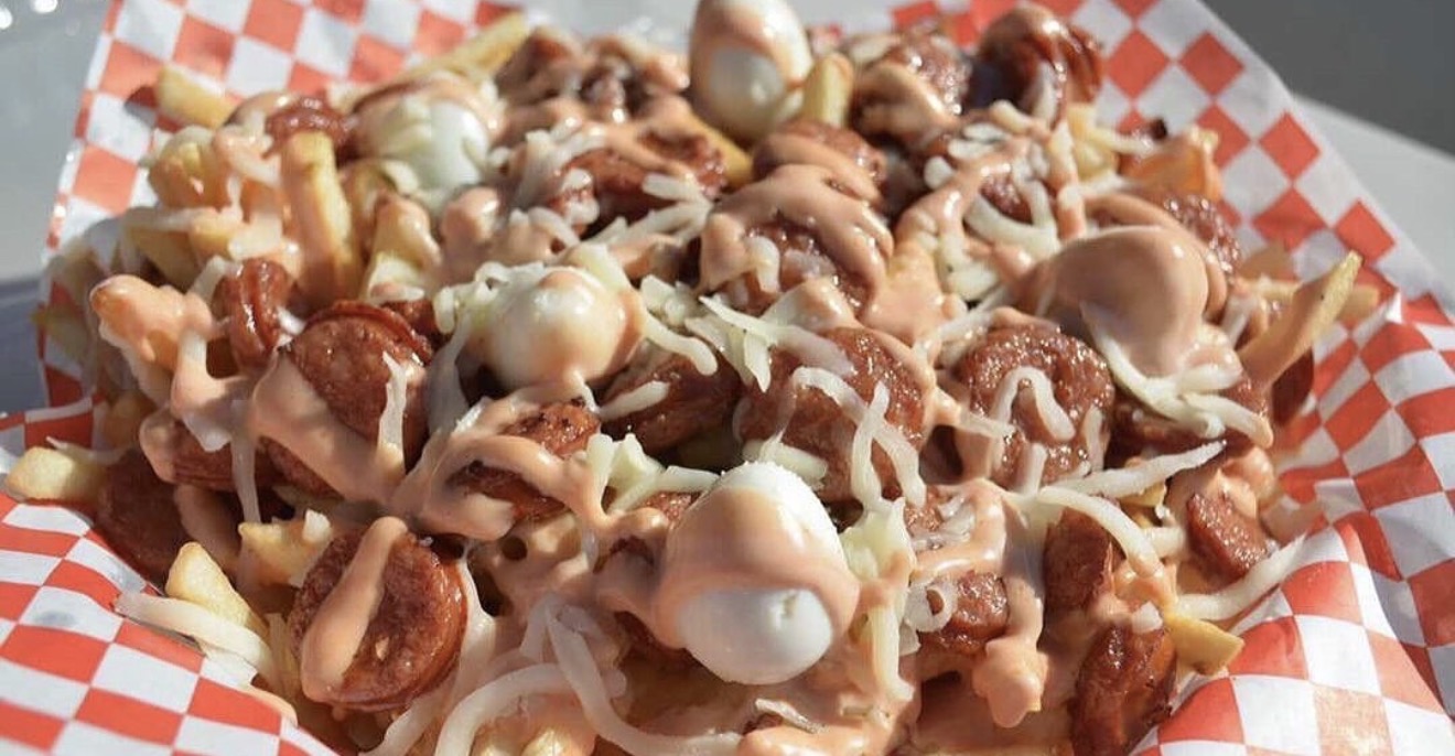 Salchipapas with chorizo, cheese and our signature pink sauce